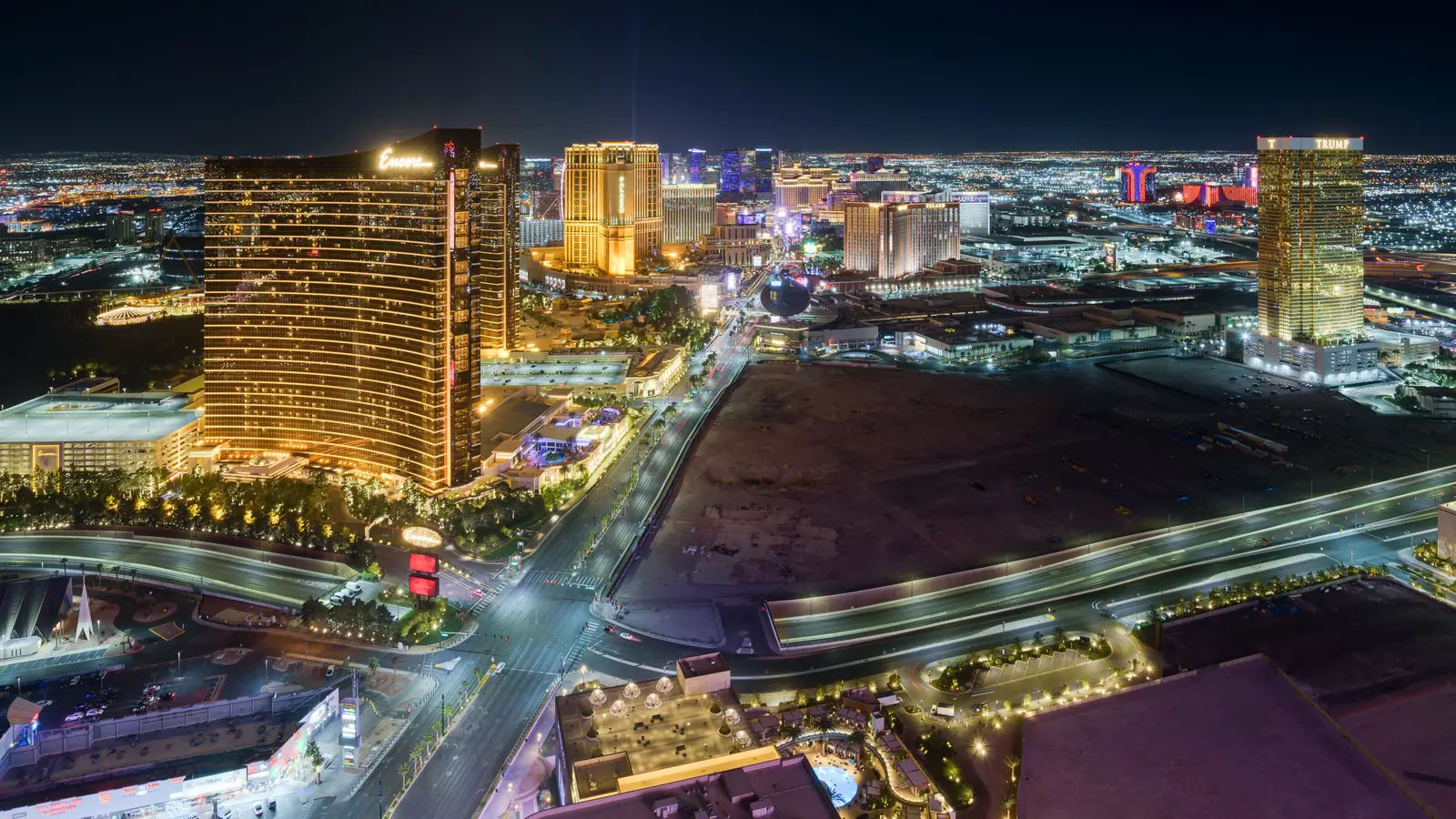 The Las Vegas Strip lit up at dusk, seen from high above.