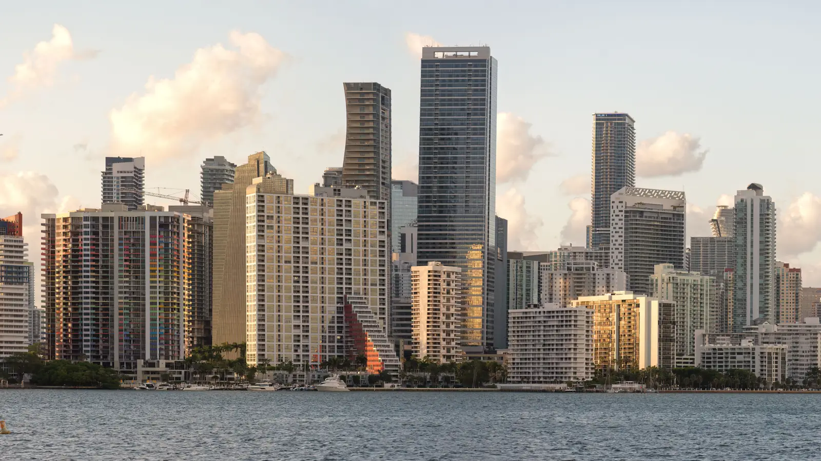Downtown Miami and Brickell high-rises along Biscayne Bay in soft late-afternoon light.
