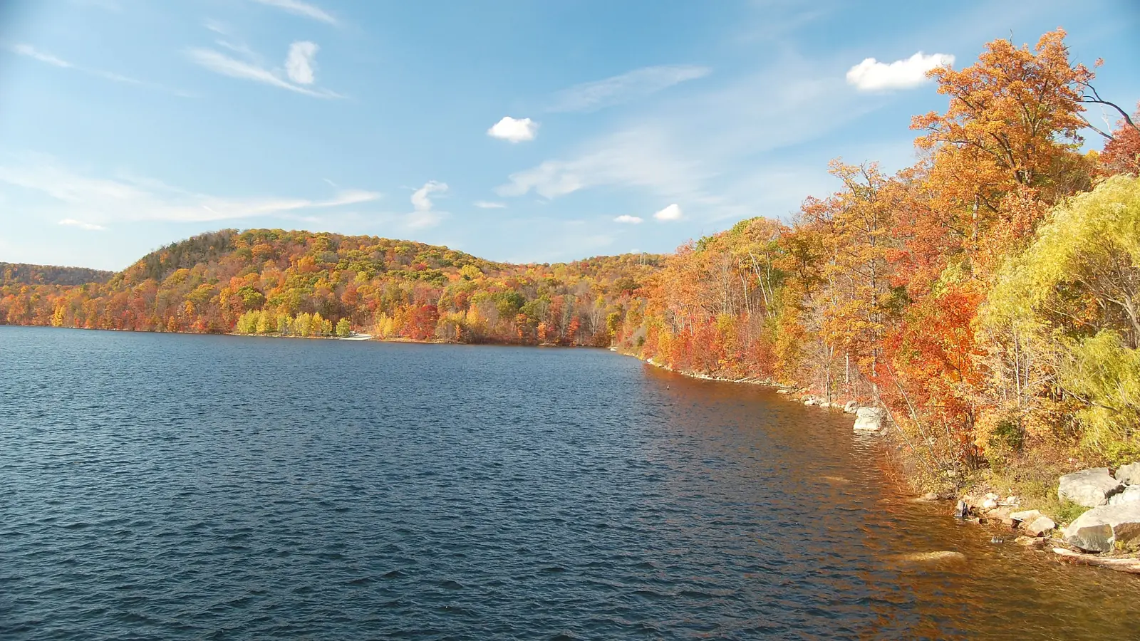 Monksville Reservoir in northern New Jersey with autumn-coloured hills along the shore.