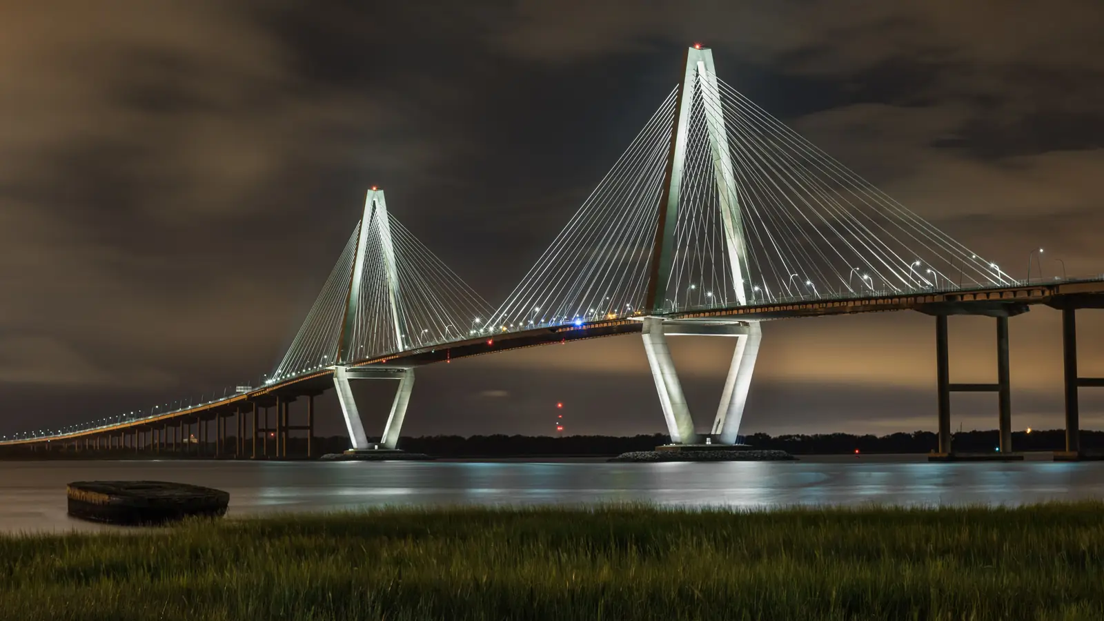The Arthur Ravenel Jr. Bridge lit at night over Charleston Harbor, South Carolina.