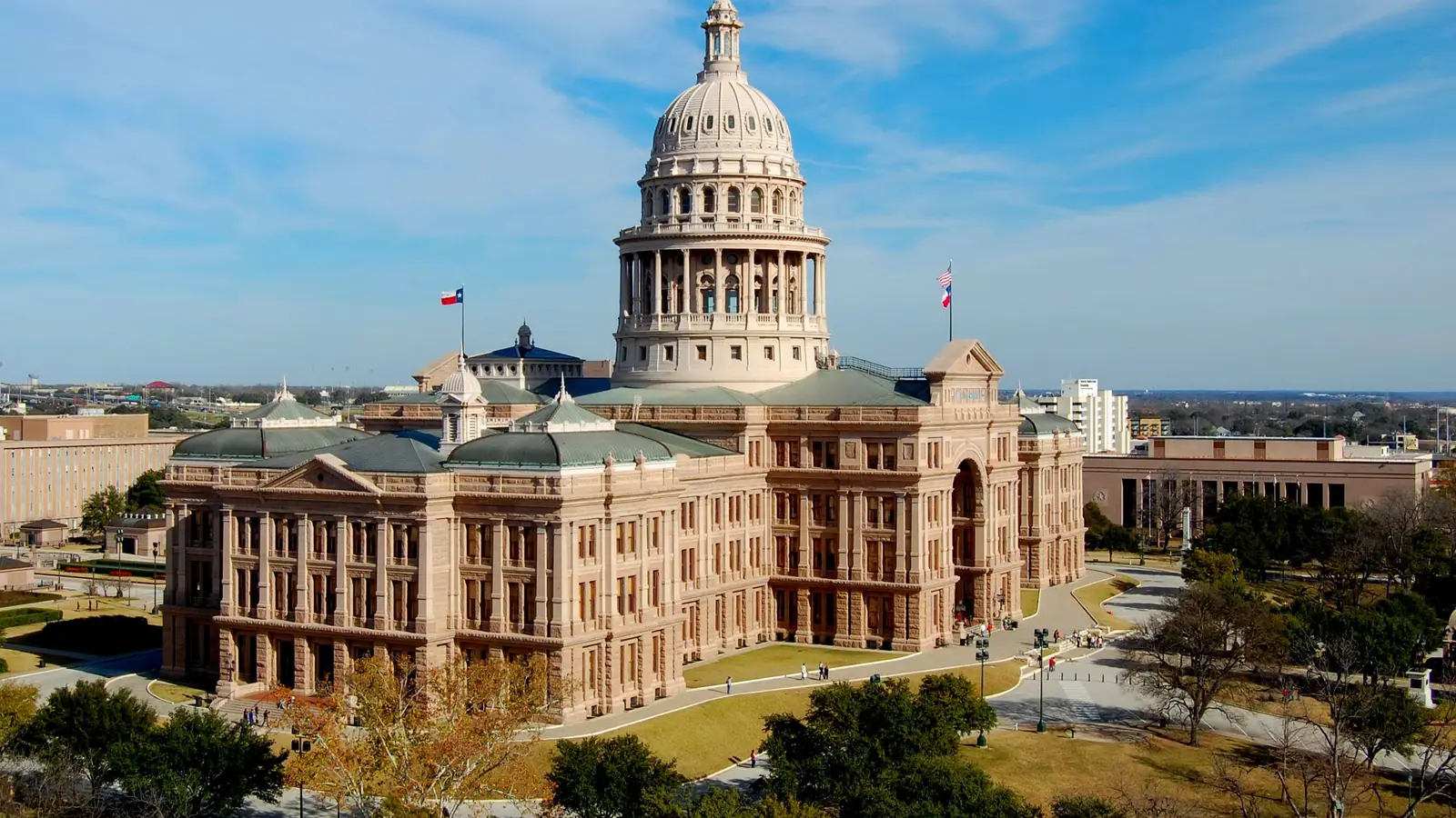 The Texas State Capitol in Austin, Texas, under a blue sky.